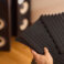 setting up audio equipment with soundproofing panels in a modern studio environment