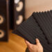 setting up audio equipment with soundproofing panels in a modern studio environment