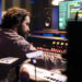 audio technician working on recording and editing new music in studio